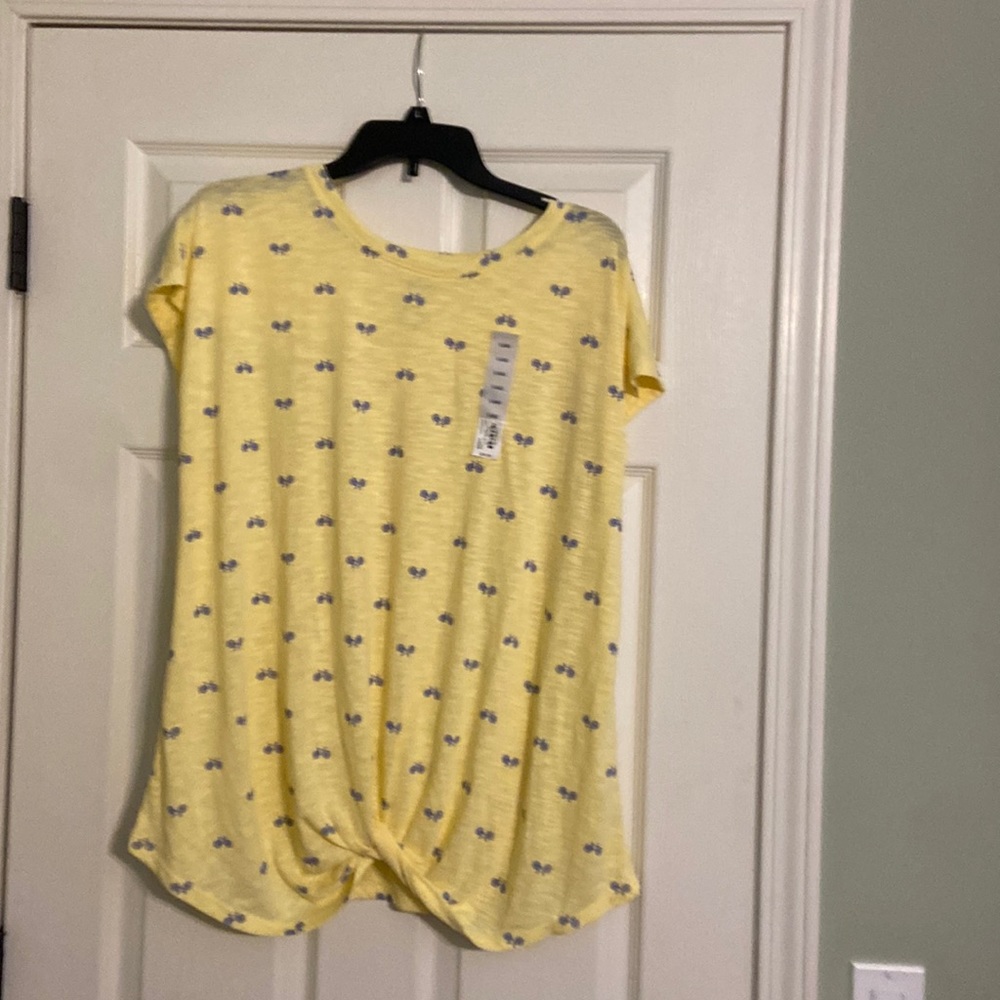 Adorable yellow top with blue bicycles on it. Twisted knot on bottom of top.